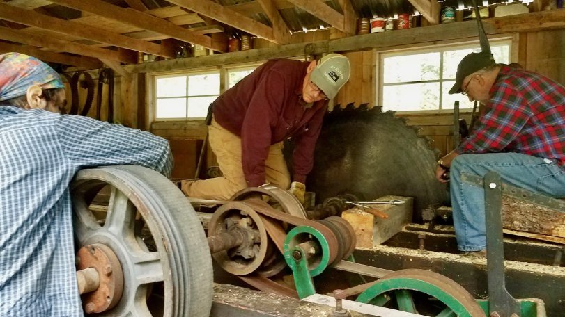 Volunteers fixing the rotary sawmill.